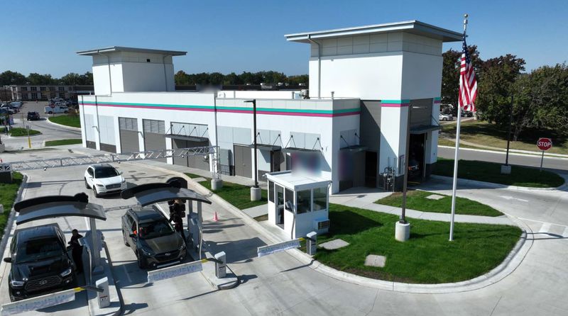 Aerial view of a car wash with vehicles queuing at the pay stations